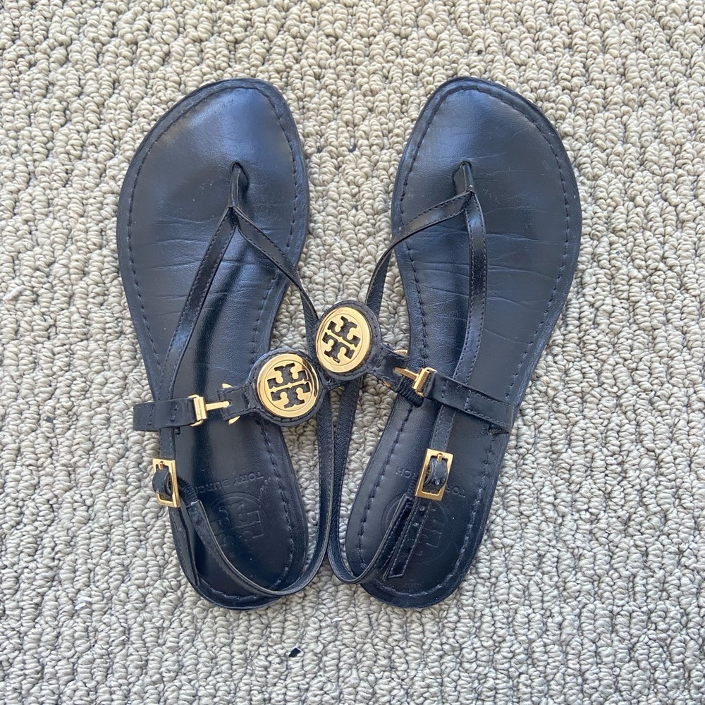 Tory Burch Ali-Anteka Black and Gold Sandals with T-Strap Design